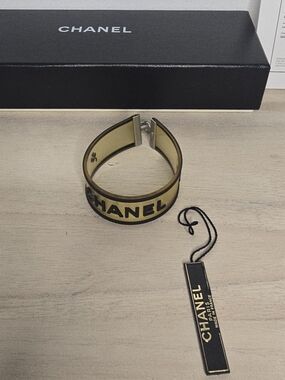 CHANEL Logo Camellia Light Yellow Rubber Cuff Bracelet authenticated